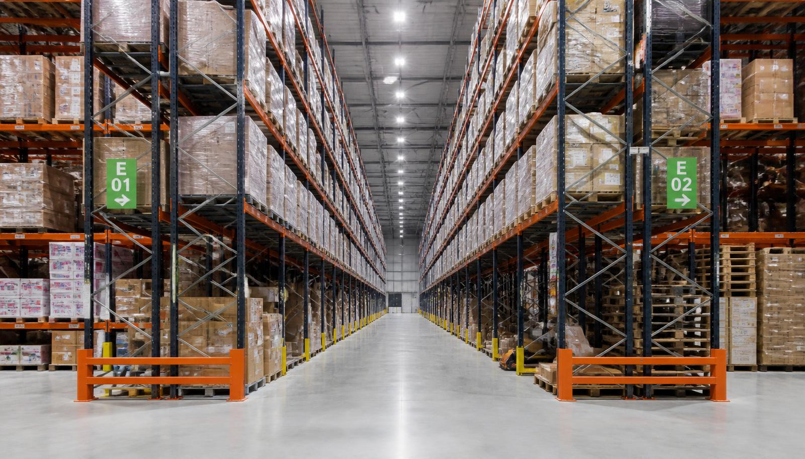 Warehouse aisle comparison: patchy old lighting against uniform LED illumination